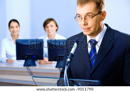 Successful business man delivers oneself of a speech at a conference