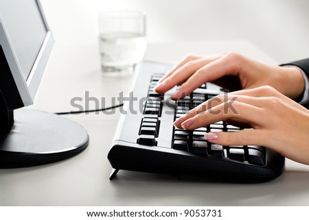 Photo of female hands on the keyboard of computer typing a letter