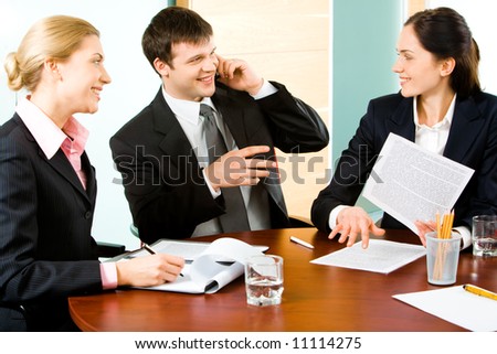 Portrait of three business people interacting with each other in a working environment