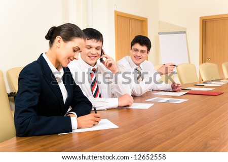 Photo of confident businessmen looking at pretty secretary during meeting in the office