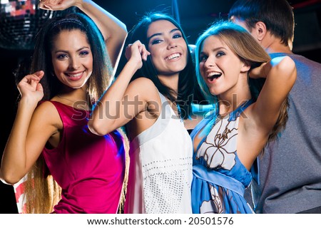 Three Laughing Girls Dancing Together In Clib At Party With Man In ...