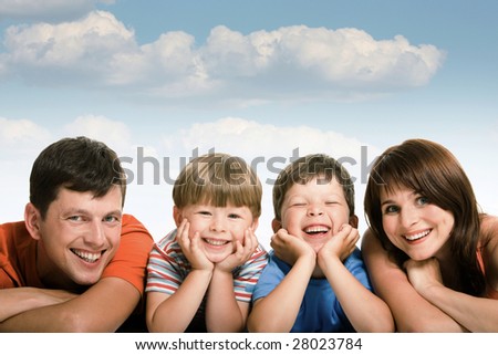 Line of happy family members looking at camera and smiling over white background