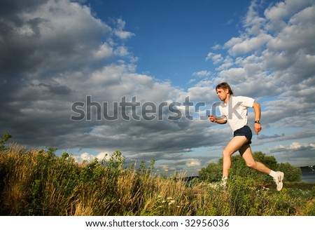 Photo of strong man running along the river