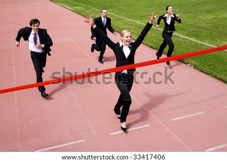 Image of joyful businesswoman winning a business race
