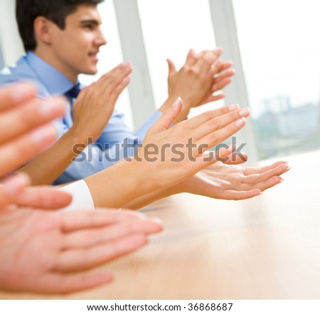 Photo of happy business partners hands applauding at meeting