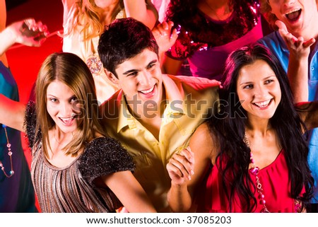 Joyful Teens Enjoying Themselves In Night Club While Dancing Stock ...