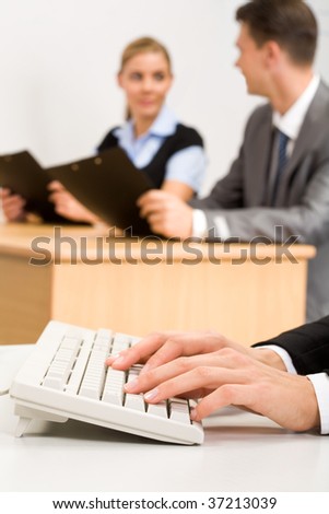 Vertical photo of female?s hands pushing buttons of computer keyboard in working environment