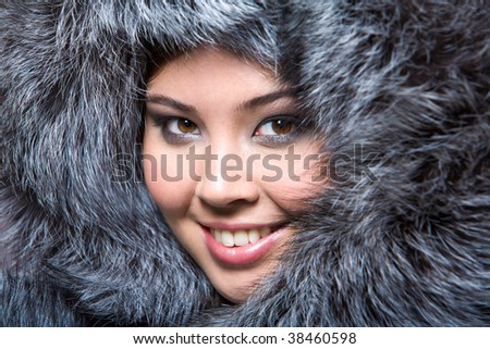 Face of pretty woman wearing luxurious furs