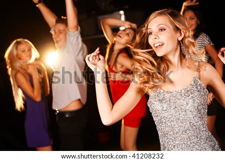 Portrait Of Energetic Dancer On Background Of Happy Teens Having Fun ...
