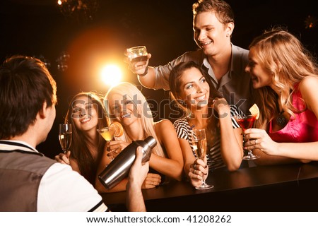 Photo of joyful friends in the bar communicating with each other