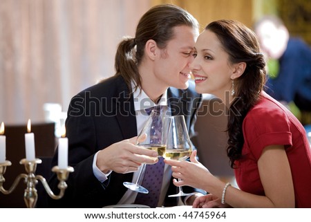 Image of amorous couple toasting in restaurant during romantic dinner