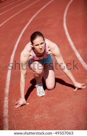 Image of sportive female ready to start running during marathon