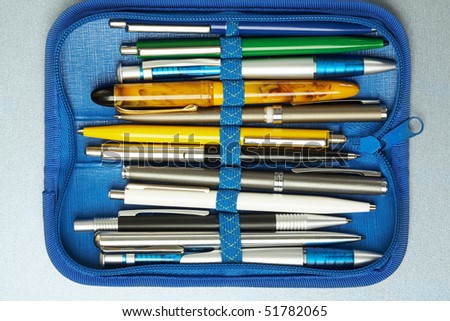 Collection of different pens placed in a blue pen-box