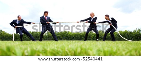 Photo of business people stretching the rope in the stadium