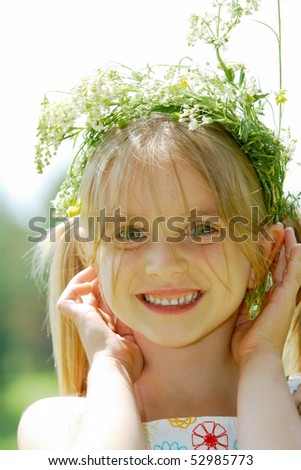 Close-Up Of Small Cute Girl Wearing Floral Wreath Looking At Camera ...