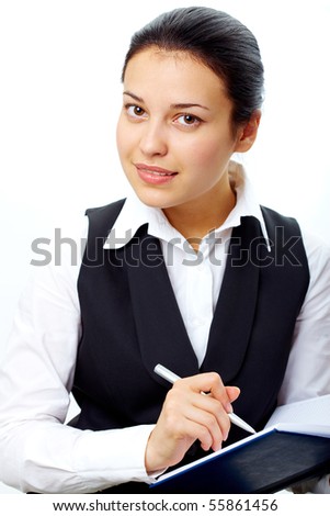 Portrait of pretty woman looking at camera during written work