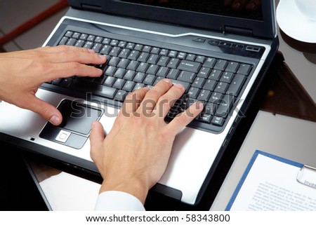 Male hands typing on the laptop