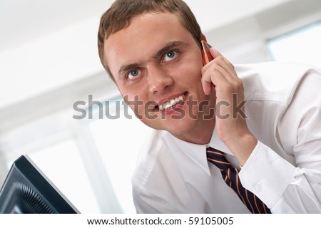 Photo of smart businessman calling somebody and smiling during communication