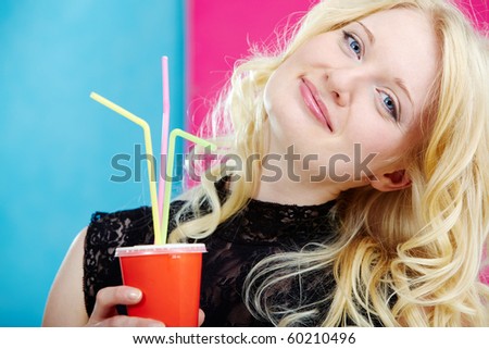 Portrait of stylish woman with soda looking at camera