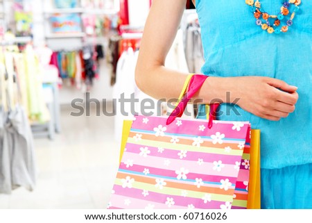 Close-up of woman?s hand holding paper bag while going shopping in the mall