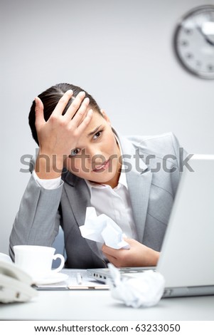 Image of young employer looking at laptop with anxiety