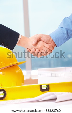 Close-up of workers doing handshake
