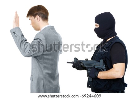 Victim standing with hands raised while mafia representative pointing gun at them behind