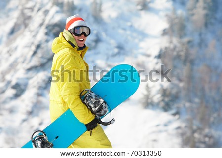 View of sportsman with snowboard standing in the forest