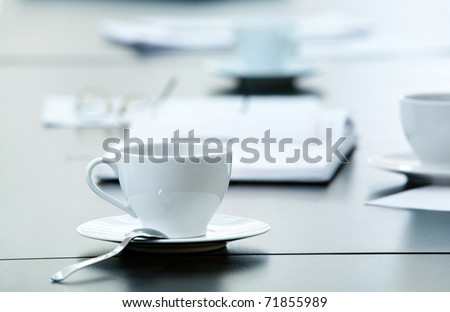 Morning workplace: cup of coffee and business objects on the table