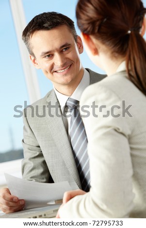 Smart businessman explaining something to his colleague in office