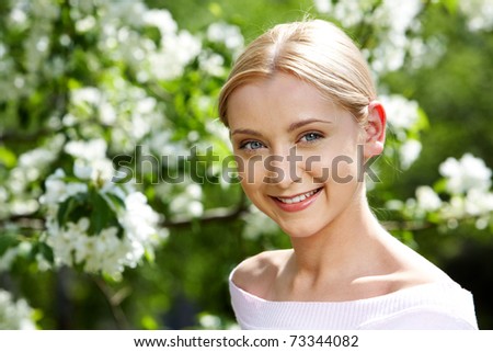 Image of happy female looking at camera on summer day