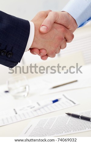Photo of handshake of business partners after striking deal