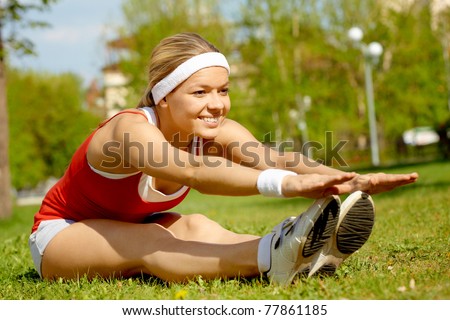 Portrait of a young woman doing physical exercise outdoors