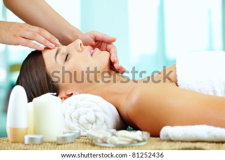 Female hands massaging young woman?s face