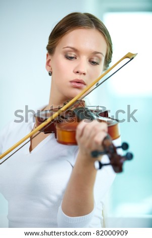 Portrait of a young female playing the violin