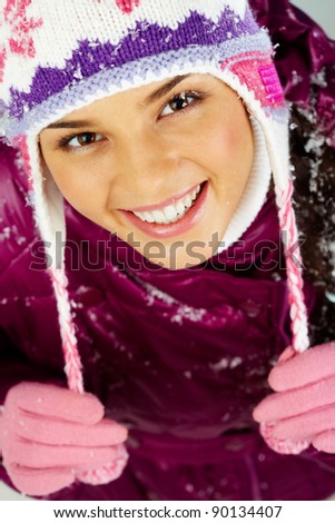 Pretty woman in winter clothes looking at camera with smile