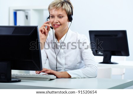Young secretary with headset answering a call