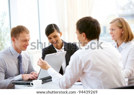 Business people sitting around the table and working together