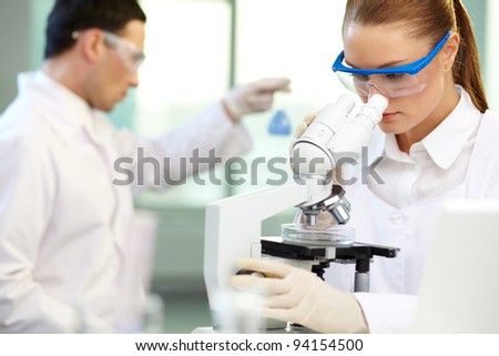 Similar – Image, Stock Photo Serious clinician studying chemical element in laboratory