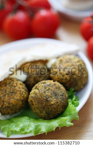 Falafel balls with pita bread,sauce,salad and tomatoes
