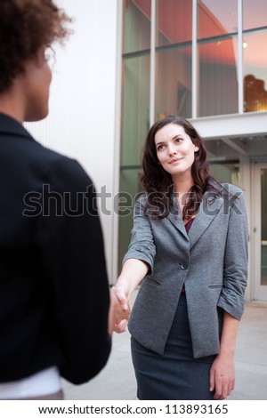 Attractive woman business team shaking hands at office