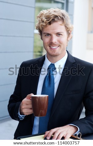 portrait of a handsome businessman with coffee mug