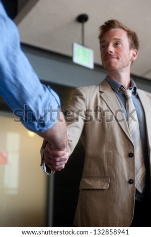 two businessmen shaking hands at office