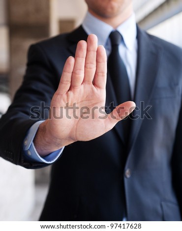 Business man holding out hand, indicating stop