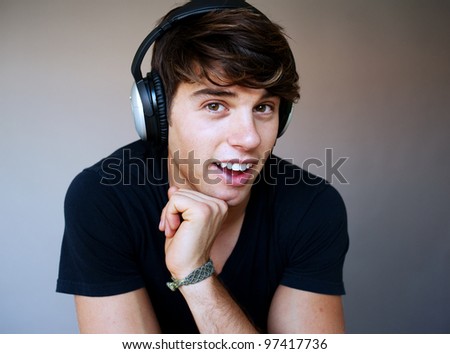 portrait of young man with headphones listening to music