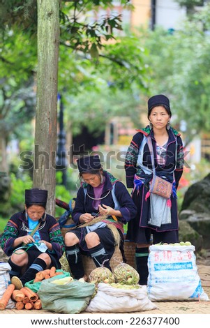 SAPA, VIETNAM Jul 04 2012: Group of Black Hmong woman on the main street on July 4, 2012 in Sapa, Vietnam. Black Hmongs are the biggest ethnic minority in north Vietnam , especially in Sapa area