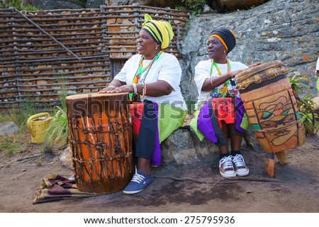 SABIE, SOUTH AFRICA - MAY 02 :Two African woman playing on traditional bongo drums on May 02,2015 in Sabie,South Africa. Drums are so iconic of Africa that an African drummer is almost a stereotype
