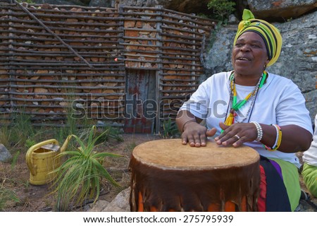 SABIE, SOUTH AFRICA - MAY 02 :African woman playing on traditional bongo drum on May 02,2015 in Sabie,South Africa. Drums are so iconic of Africa that an African drummer is almost a stereotype