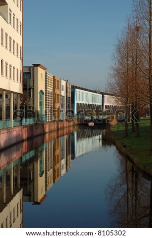 Modern houses reflecting in the water of a canal. Kattenbroek (suburb), Amersfoort, Holland