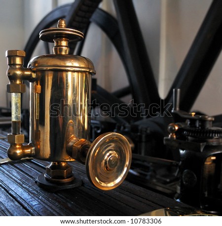Brass oil dispenser on an old steam engine in water pump house